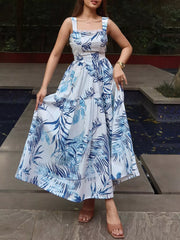 Maxi dress with blue tropical leaf print, lace trim, square neckline, and tiered skirt.