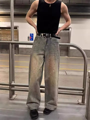 Vintage wash wide-leg jeans with distressed details and paint splatters.