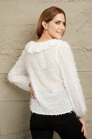 White textured ruffle front blouse with balloon sleeves and a sheer, fuzzy overlay.