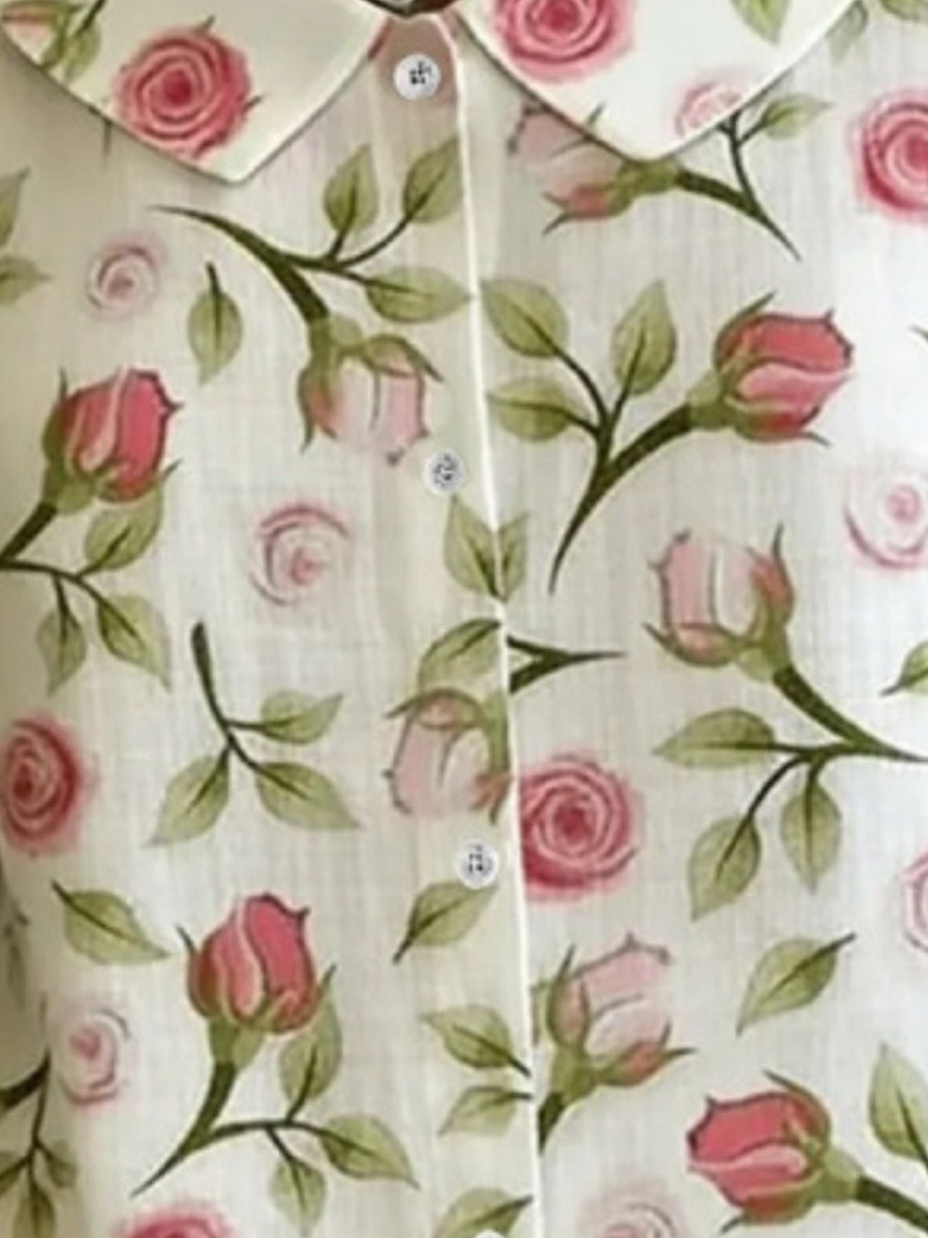 Peter Pan collar shirt in Floral print with button-down front and rose pattern.