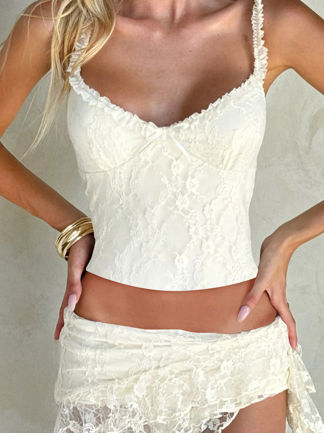 White lace bustier top with ruffle straps and a small bow detail.