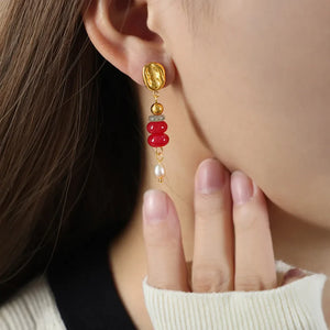 18K gold-plated dangle earrings with red stacked gemstones and a pearl drop.