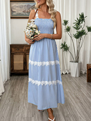 Blue striped midi dress with smocked bodice and lace trim.