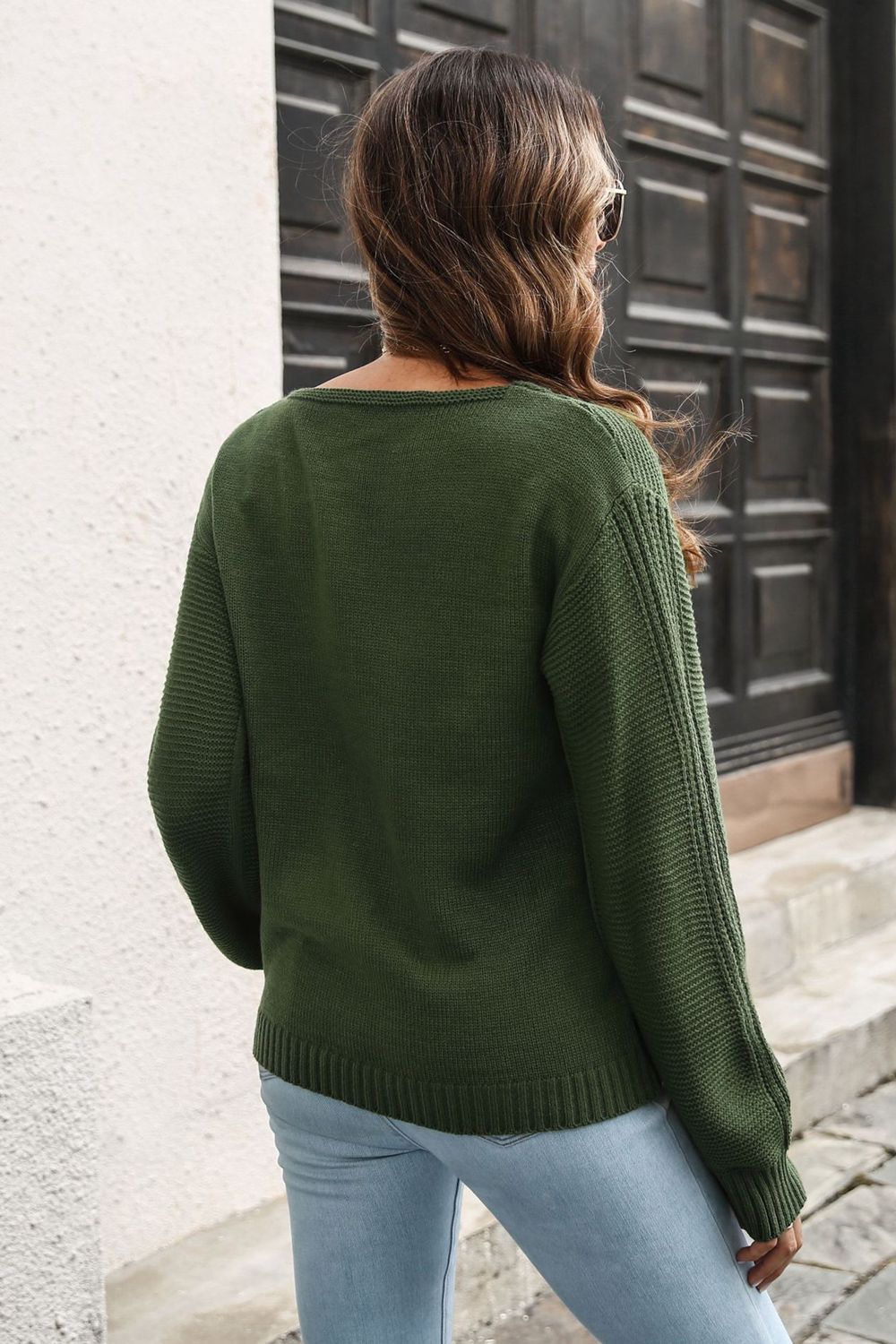 Army green acrylic V-neck sweater with vertical ribbed sleeves and hem.