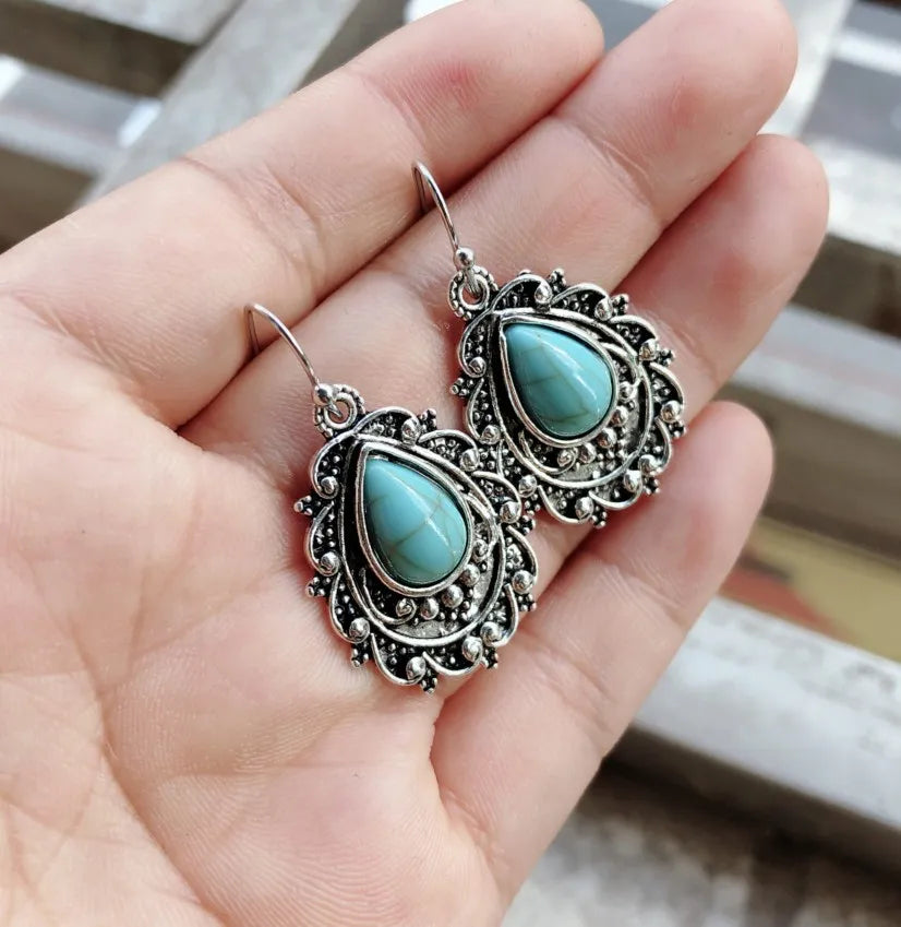 Turquoise teardrop filigree earrings with antique silver metalwork.