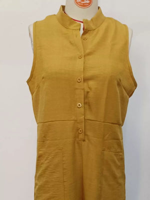 Yellow button-down sleeveless romper with mandarin collar and pockets.