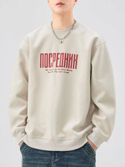 Oversized graphic sweatshirt in apricot with red text graphic, crewneck, long sleeves, and cotton blend.