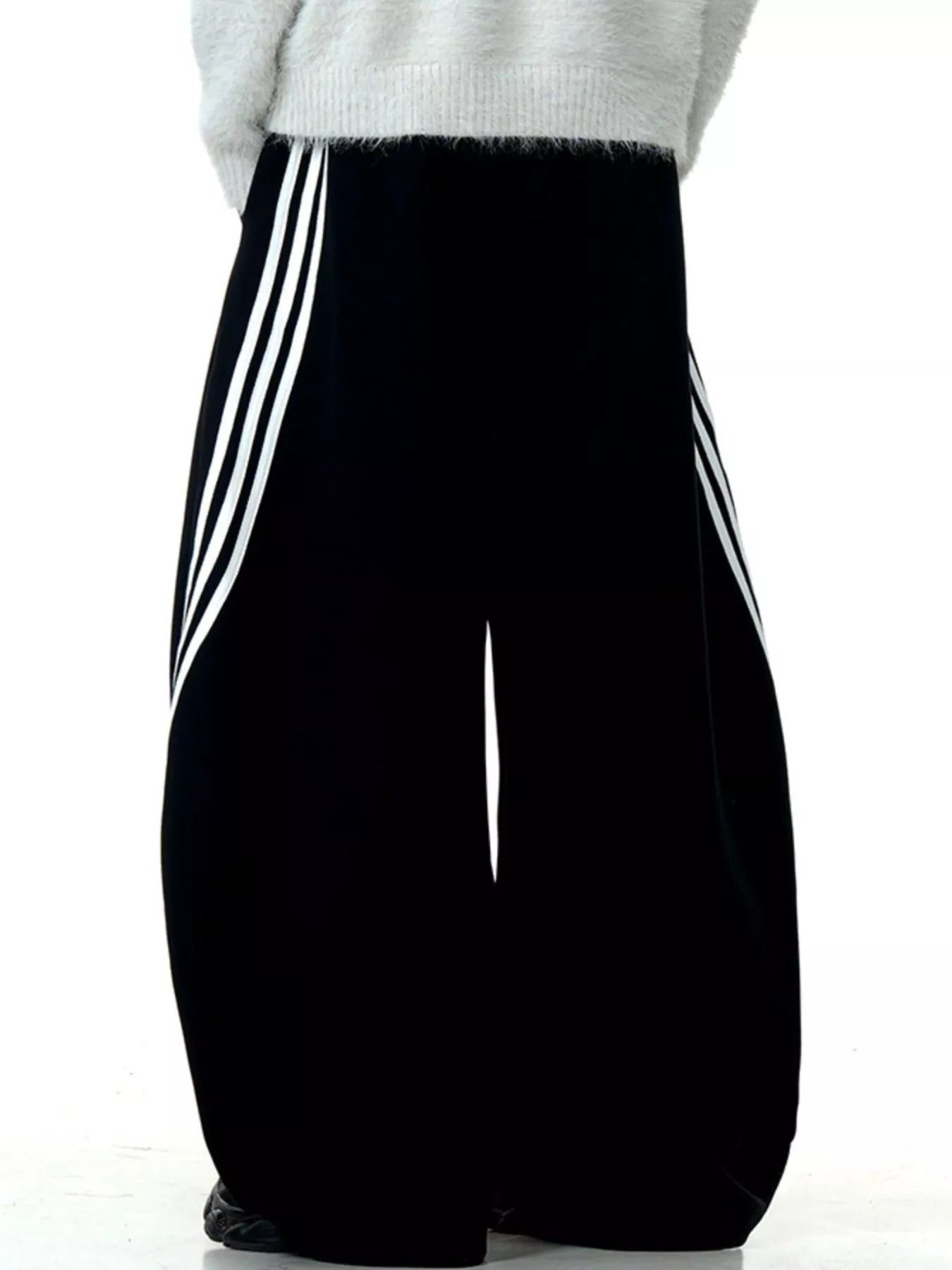 Men's black wide-leg sweatpants with white side stripes and a relaxed fit.