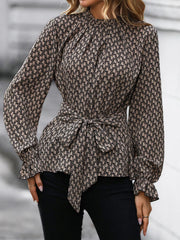Tied ruffled flounce sleeve blouse in khaki with a geometric print and tie waist.