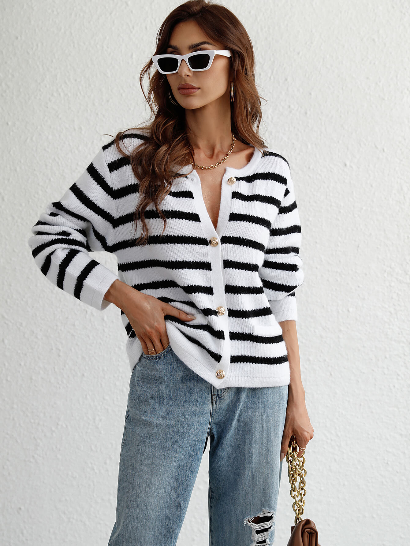 Black and white striped knit cardigan with button front and pockets