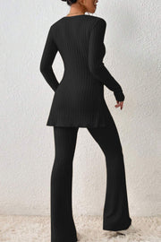 Black ribbed knit co-ord set with flared pants and side slit tunic.