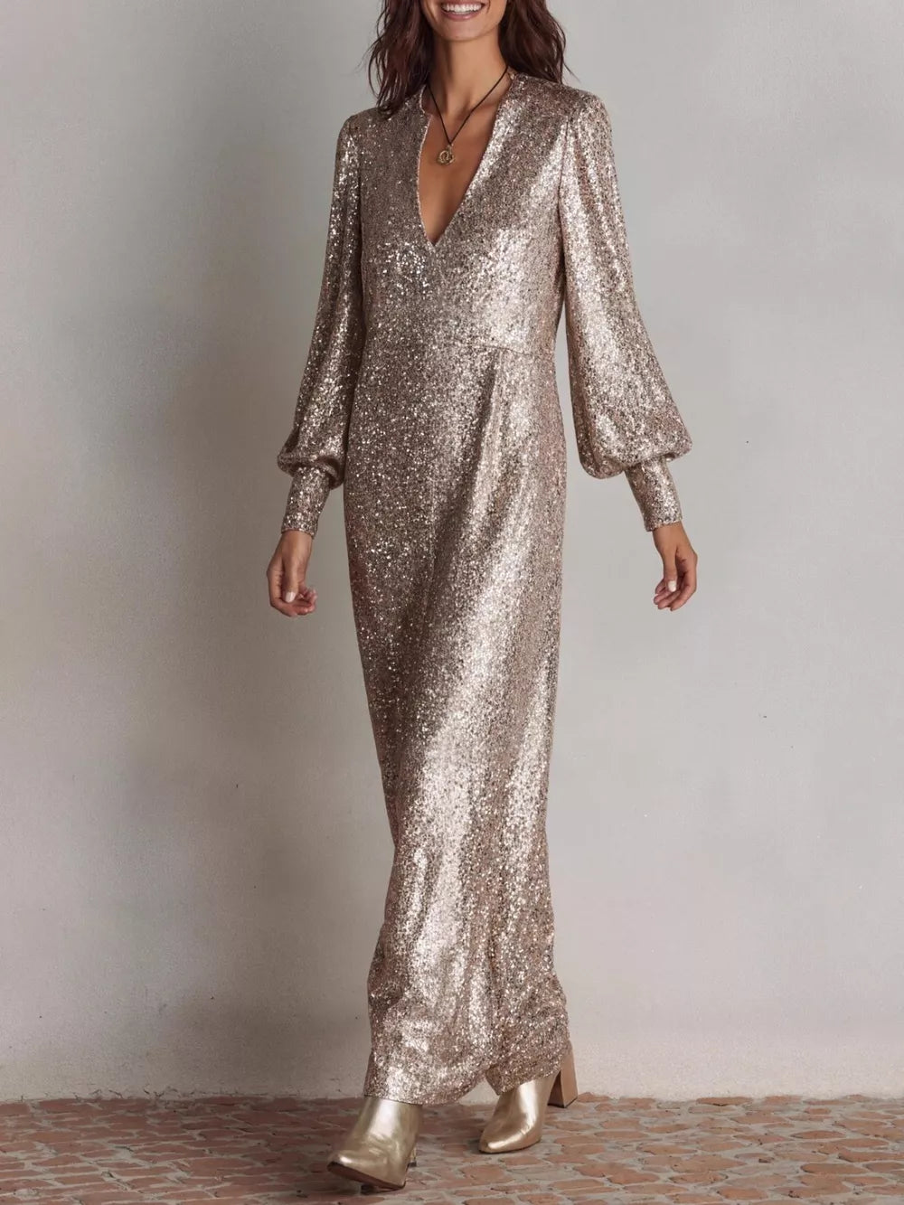 Champagne sequin maxi gown with V-neck and lantern sleeves.