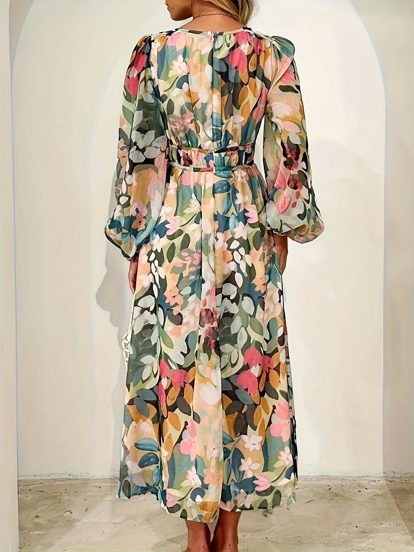 Floral print midi dress with V-neck, long sleeves, and belted waist in beige and white.