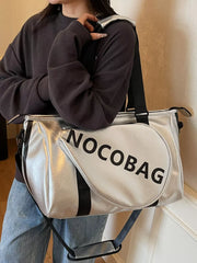 Silver leather duffel bag with black stripes and text detail, detachable strap.