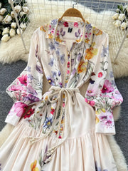 Vibrant floral midi dress with lantern sleeves, button front, and tie waist.