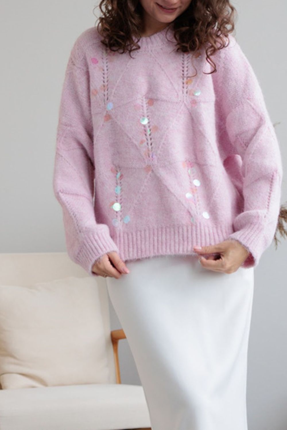Blush pink diamond knit sweater with scattered iridescent sequins and openwork details.