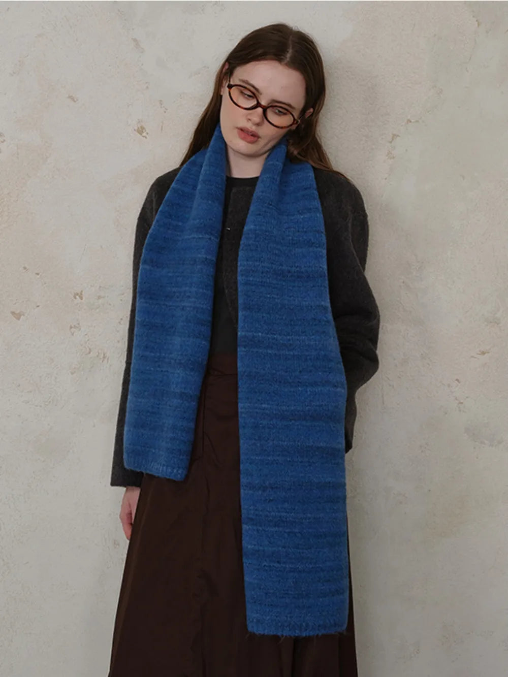 Textured mélange knit scarf in Royal Blue, styled casually.