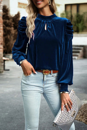Velvet keyhole puff-sleeve blouse in dark blue with smocked cuffs.