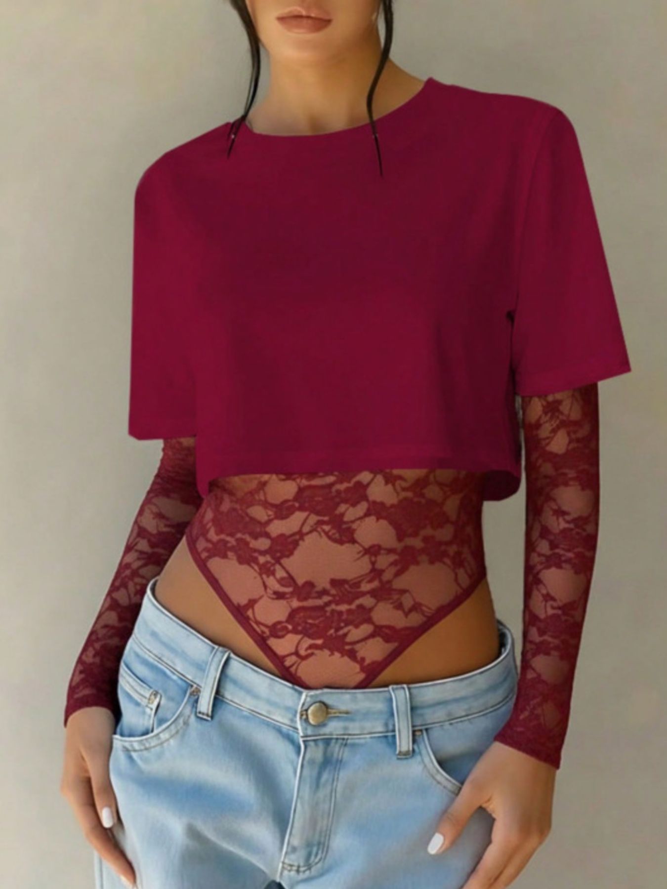 Wine red lace bodysuit with sheer long sleeves and a cropped top overlay.
