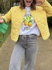 Yellow quilted snap puffer jacket with a round neckline and button closure.