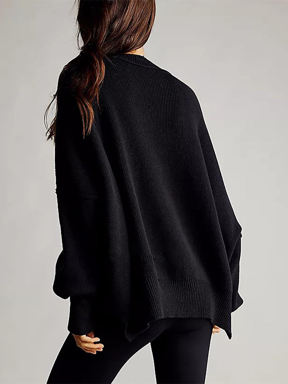 Black oversized ribbed knit sweater with drop shoulders and a relaxed fit.