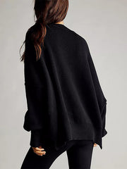 Black oversized ribbed knit sweater with drop shoulders and a relaxed fit.