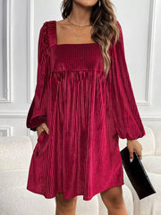 Velvet mini dress with square neckline, pleated texture, and balloon sleeves.