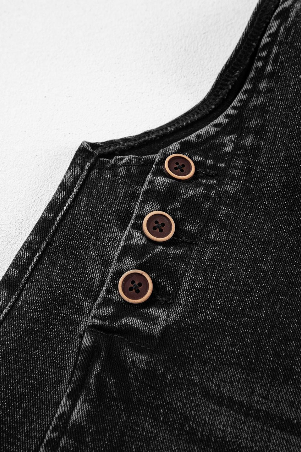 Black denim culotte overalls with wooden button detail on the bib.