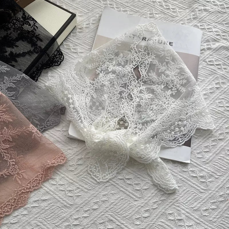 Delicate floral lace scarf in off-white with a tied knot detail.