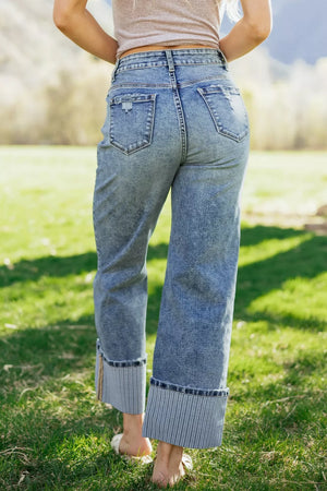 Cuffed mid-rise relaxed fit jeans in light wash denim with distressed details and striped cuffs.
