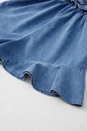 Medium wash denim romper with ruffled hem detail