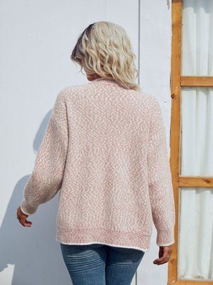 Blush pink textured knit cardigan with a geometric pattern and contrast trim.