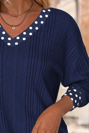 Navy ribbed blouse with polka dot V-neck and cuffs