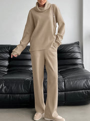 Beige cowl-neck turtleneck and pants set with pockets.