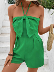 Green halterneck romper with bow-front detail and smocked back.
