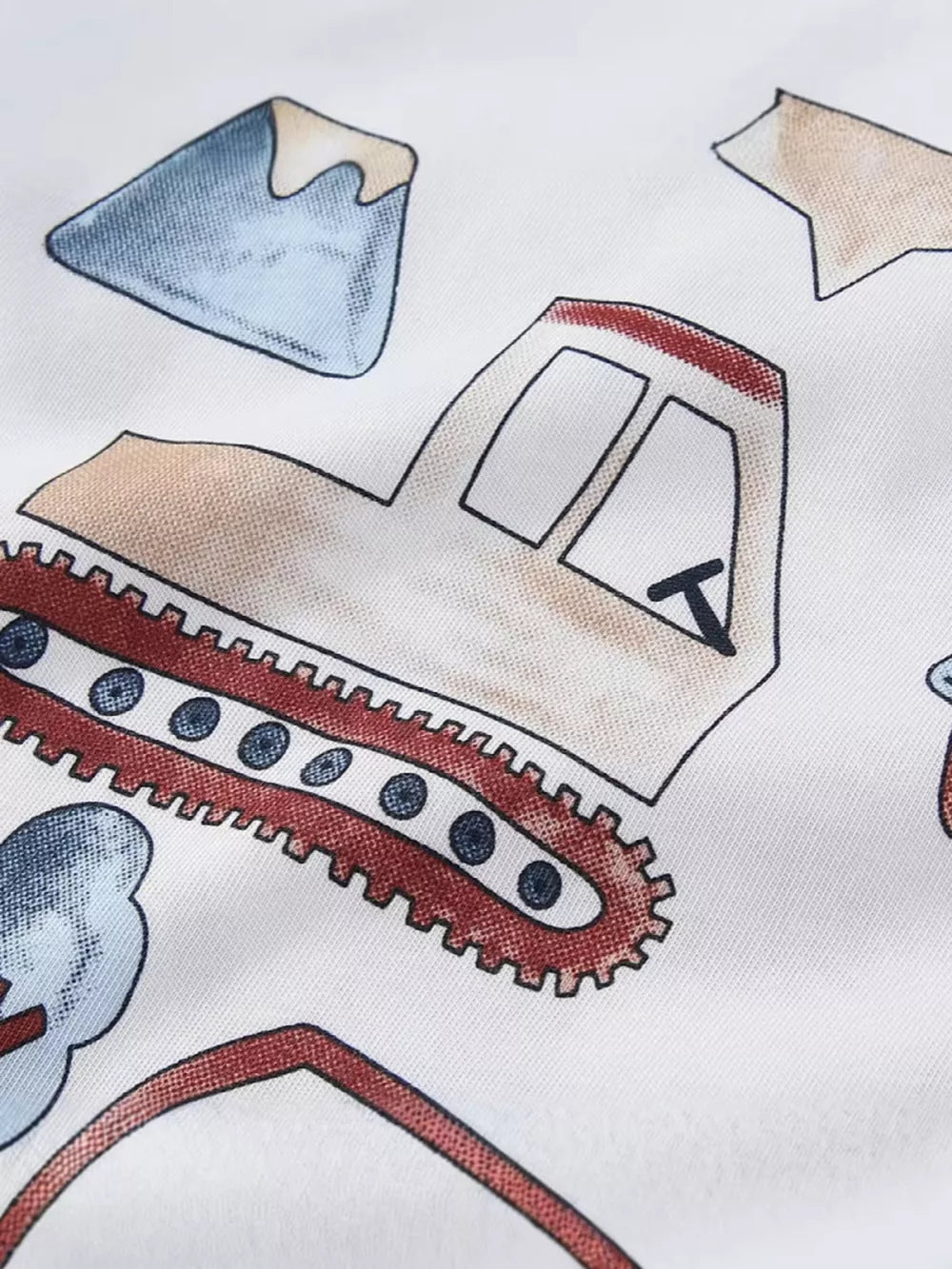 White cotton t-shirt with playful construction truck graphic and mountain details.