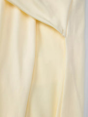 Yellow ruched halter neck maxi dress detail showing fabric texture and draping.
