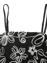 Black cami top with white floral embroidery and adjustable straps