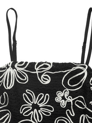 Black cami top with white floral embroidery and adjustable straps