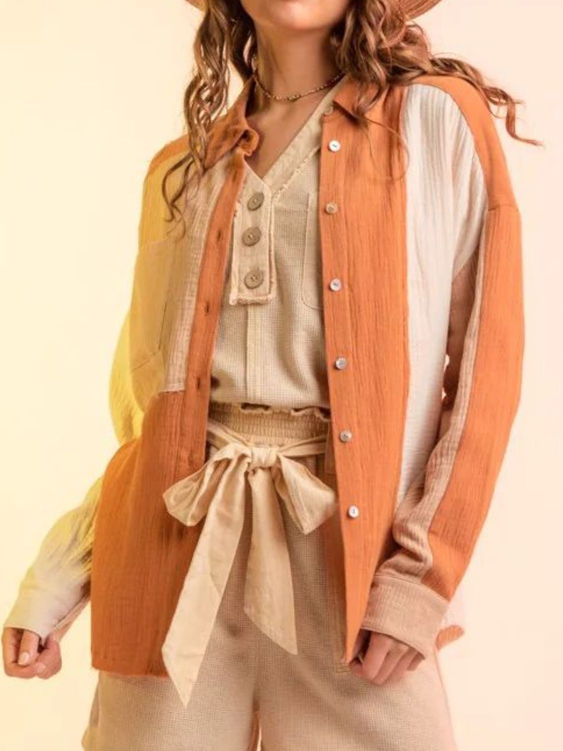 Colorblock gauze shirt jacket in apricot and cream with button front and collar.