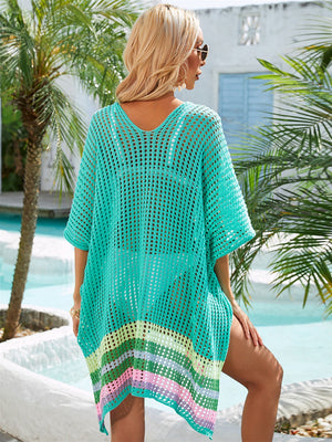Turquoise crochet beach cover-up with rainbow stripes at the hem.