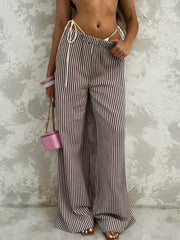 Tied striped wide-leg pants in brown and white, featuring a high waist and flowy silhouette.