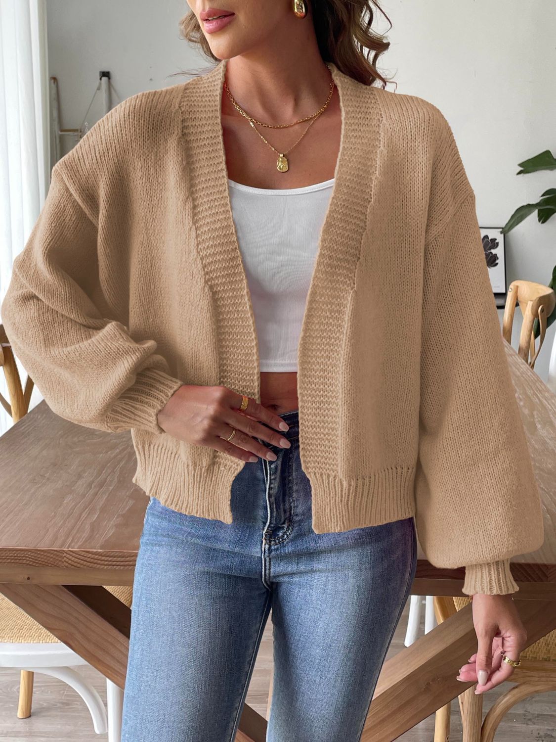 Tan balloon sleeve knit cardigan with open front and ribbed cuffs and hem.