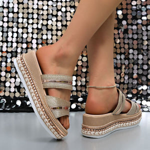 Glamorous wedge sandals with metallic straps and studded trim, featuring a woven espadrille platform.
