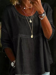 Black bohemian t-shirt with openwork detail and round neckline.