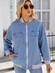 Relaxed medium wash denim bomber jacket with ribbed collar, cuffs, and hem.