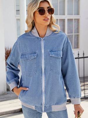 Relaxed medium wash denim bomber jacket with ribbed collar, cuffs, and hem.