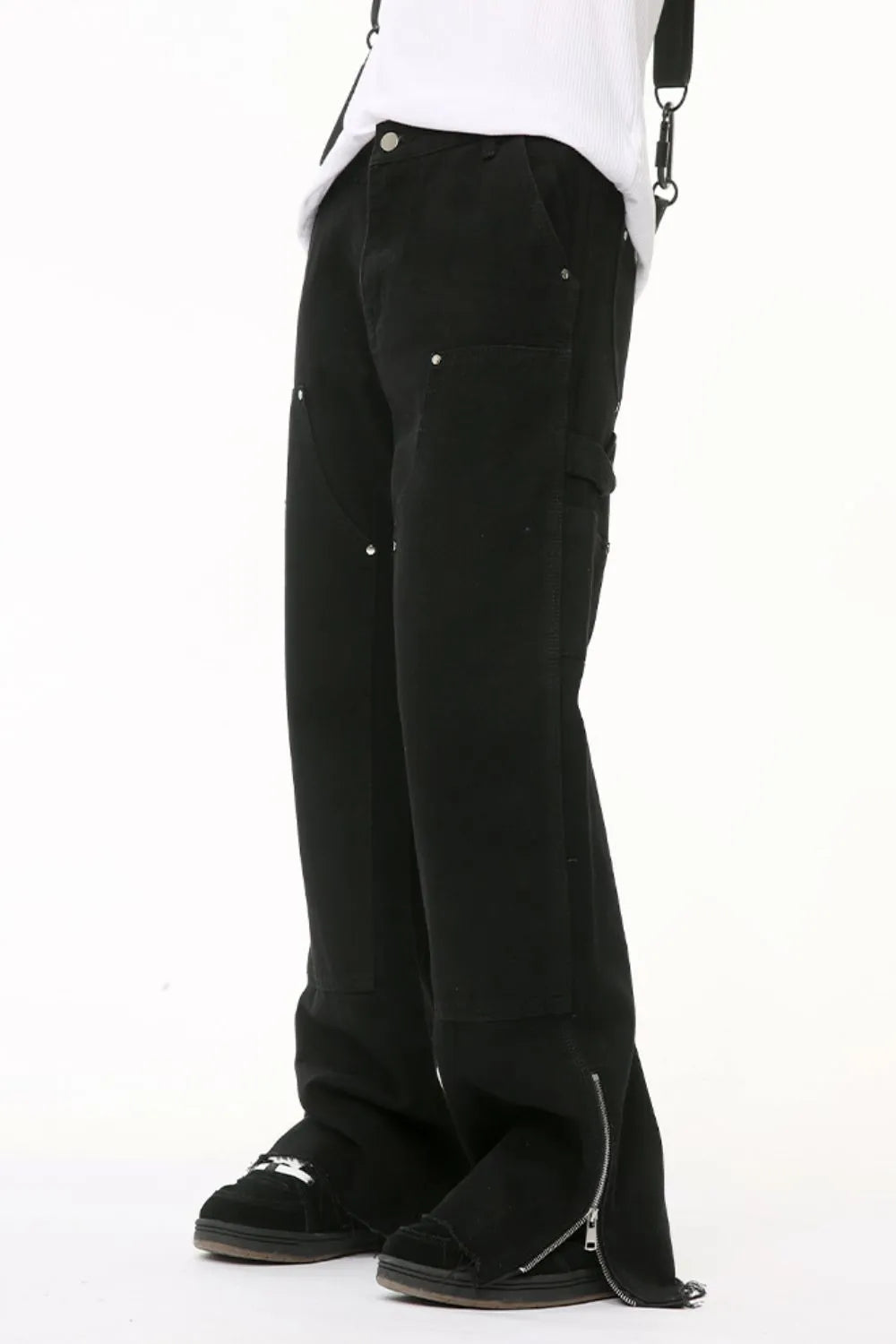 Black bootcut denim pants with zip hem detail and utility pockets.