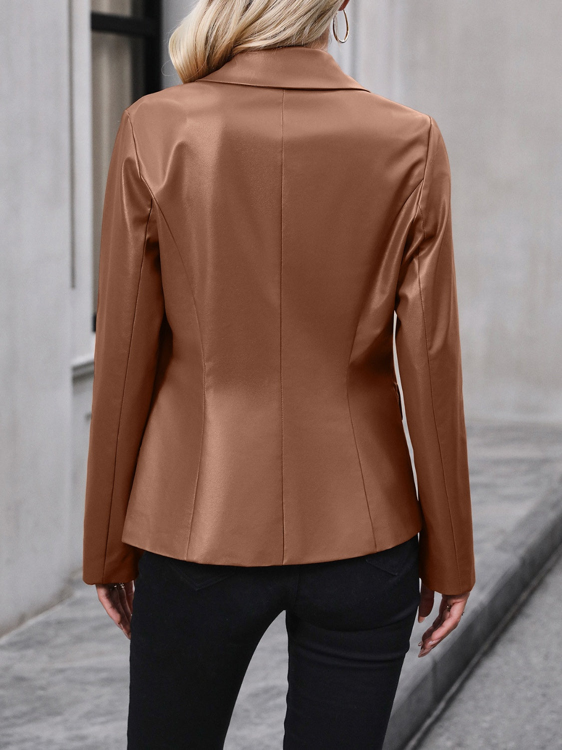Brown faux leather double-breasted blazer with a classic collar and long sleeves.