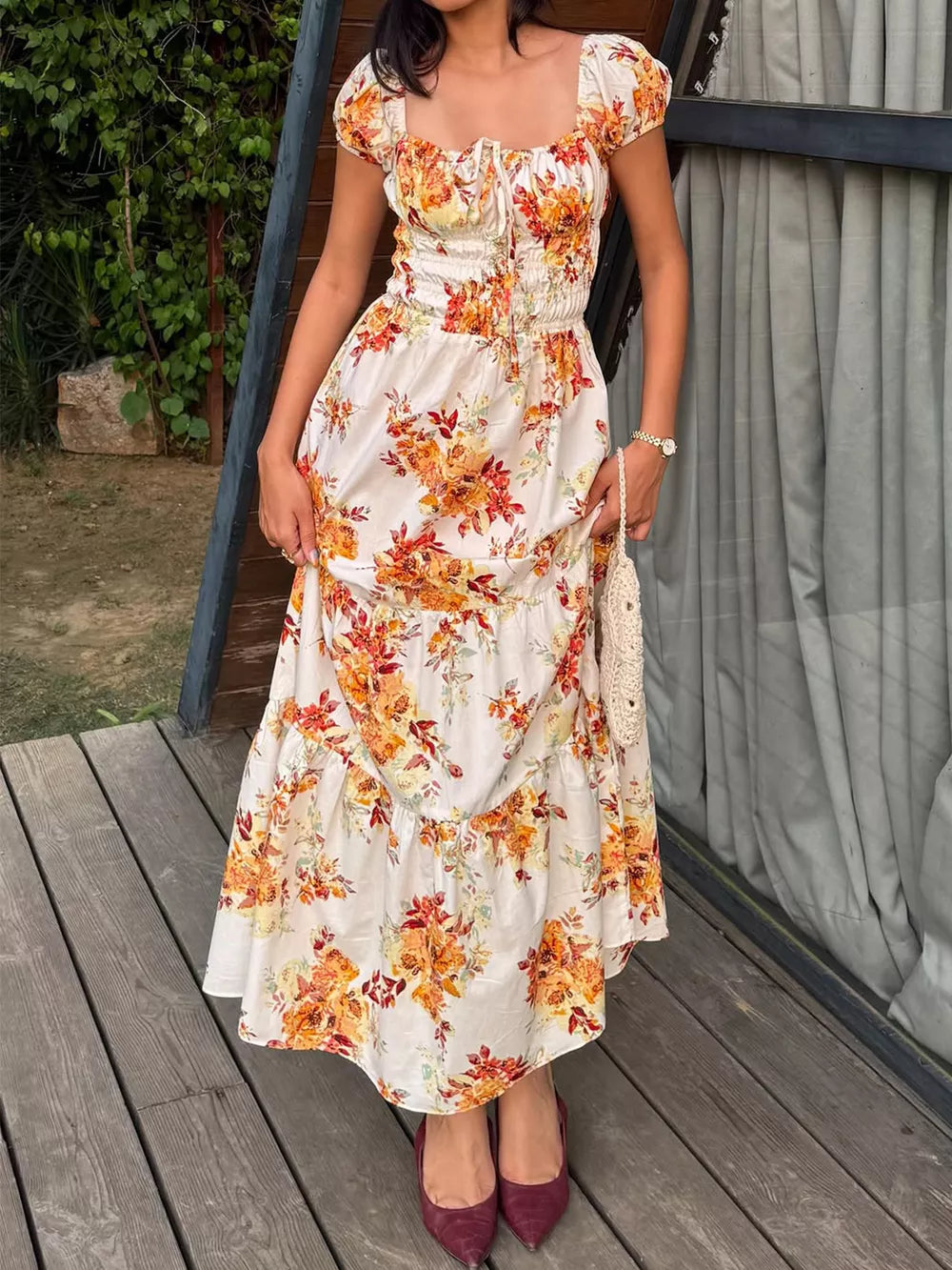 Floral tie-detail ruched waist midi dress with puff sleeves and a tiered skirt.